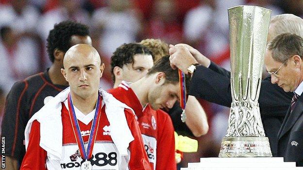 Massimo Maccarone walks past the Uefa Cup trophy