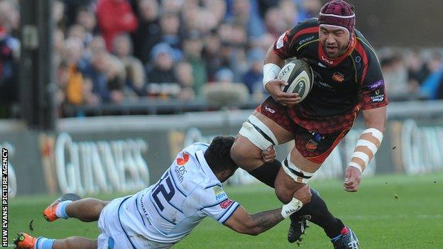 Brandon Nansen of the Dragons is tackled by Willis Halaholo