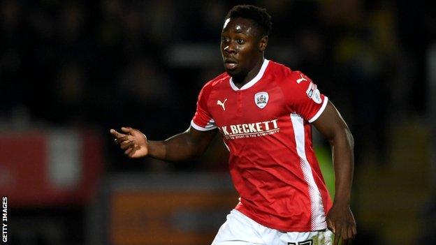 Barnsley full-back Andy Yiadom runs with the ball against Burton Albion