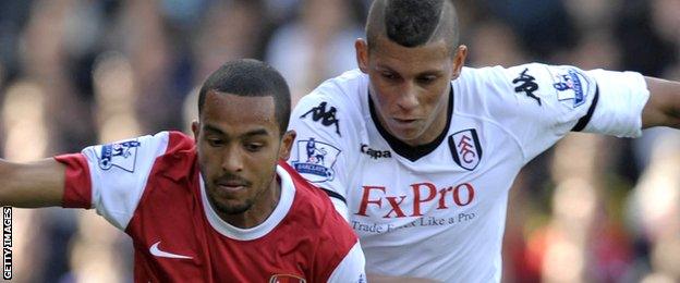 Matthew Briggs (right) jostles with Theo Walcott