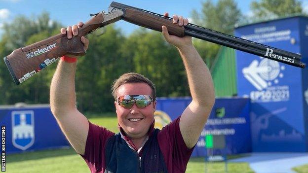 Matthew Coward-Holley celebrates winning trap gold at the 2021 European Shooting Championships