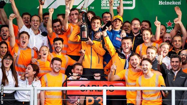 Carlos Sainz and Lando Norris with McLaren staff