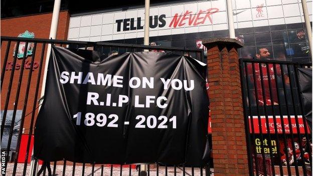 Liverpool banner saying 'shame on you, RIP LFC'