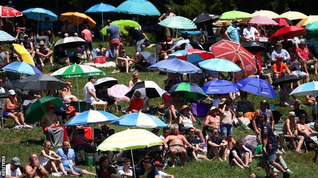 Fans shelter from the heat at the Red Bull Ring