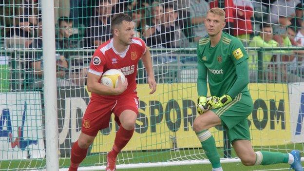 Aaron Williams retrieves the ball after scoring a penalty for Newtwon