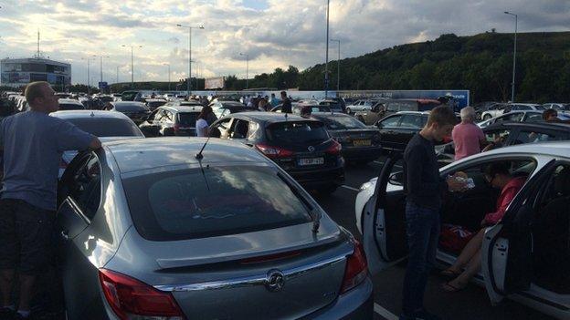 People out of their cars in stationary traffic