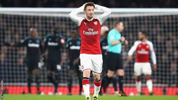 Arsenal's Mathieu Debuchy puts his hands on his head during the EFL Cup quarter-final against West Ham