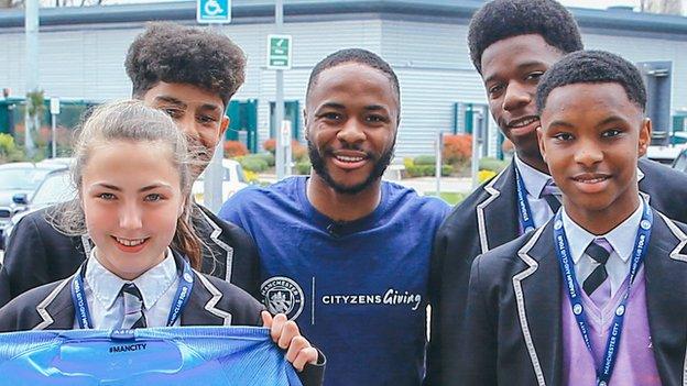 Raheem Sterling and pupils.