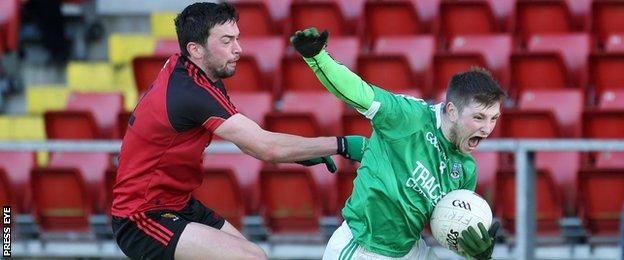 Down's Damien Turley battles with Fermanagh's Daniel Teague on Sunday at Pairc Esler