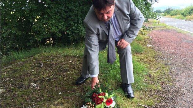 Des Lee of the Miami Showband lays flowers at the spot where his fellow band members were murdered 40 years ago