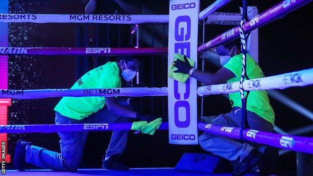 Cleaners sanitise the ring at the MGM Grand