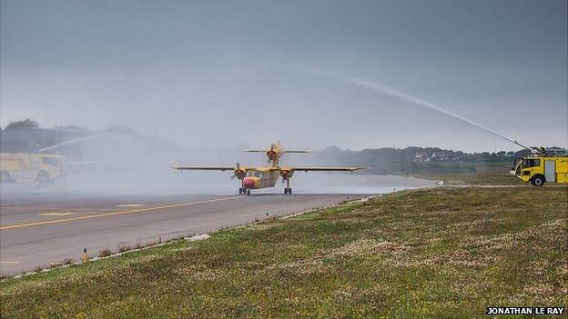 G-Joey is met by a water salute at Guernsey Airport after completing last flight