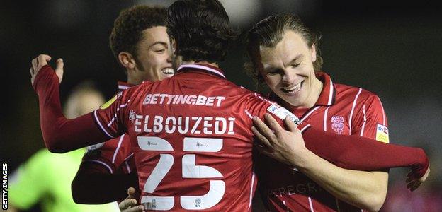 Lincoln City's Brennan Johnson, Zack Elbouzedi and Harry Anderson celebrate a goal against Burton