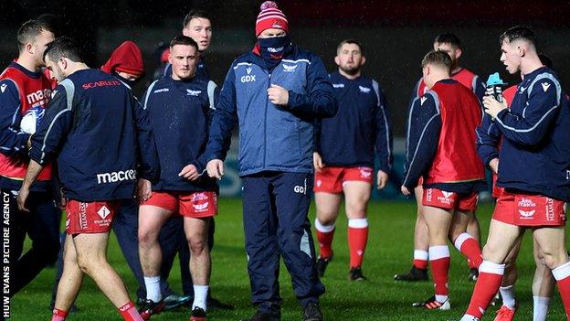 Head coach Glenn Delaney with Scarlets players at Parc y Scarlets after Toulon pulled out of the Heineken Champions Cup fixture