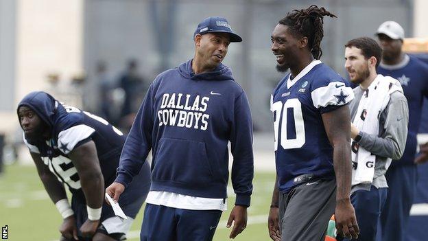 Aden Durde speaks to Dallas Cowboys' defensive end DeMarcus Lawrence