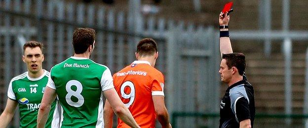 Niall Grimley begins his walk off the pitch after the midfielder is red-carded by referee Paddy Neilan