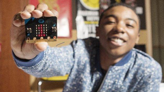 Boy holding a micro:bit computer