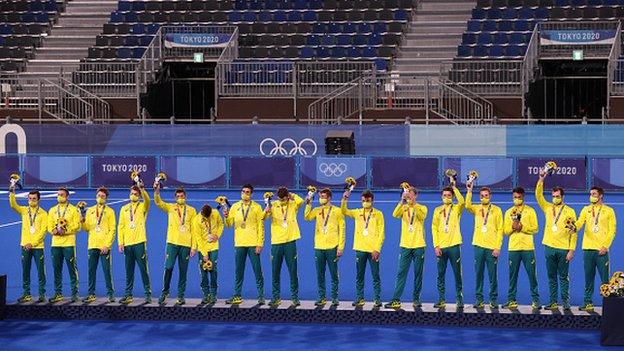 Australia's men's hockey team posing with silver medals