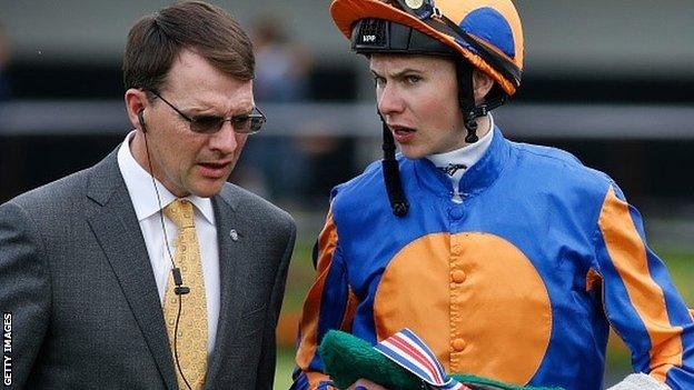 Trainer Aidan O'Brien and son Joseph talk tactics before a race