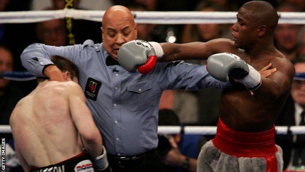 Ricky Hatton is held back by referee Joe Cortez