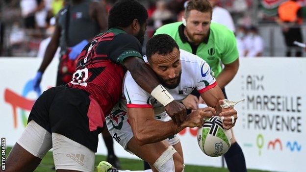 Algeria wing Nadir Megdoud (right) is tackled by Kenya's Jone Kubu Tavaga