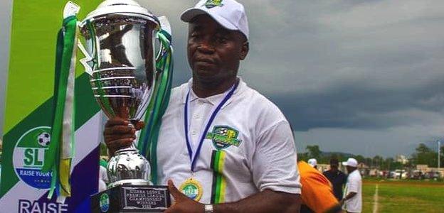 Babadi Kamara with the Sierra Leone Premier League trophy