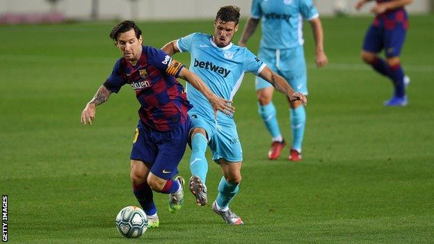 Barcelona's Lionel Messi battles for possession with Ruben Perez of Leganes