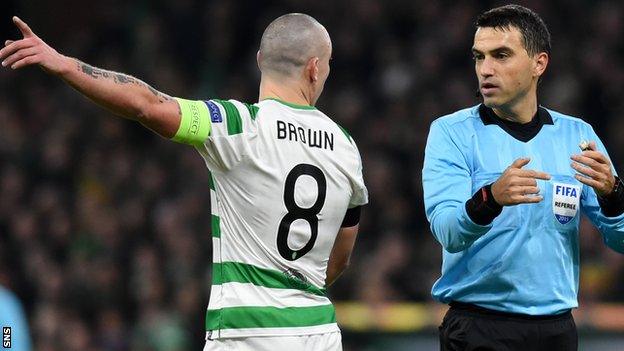 Celtic captain Scott Brown with referee Ovidiu Hategan