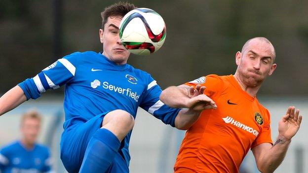 Ballinamallard's James McKenna battles with Carrick's Barry Johnston