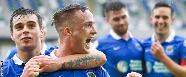 Matthew Clarke congratulates Linfield's hat-trick hero Aaron Burns