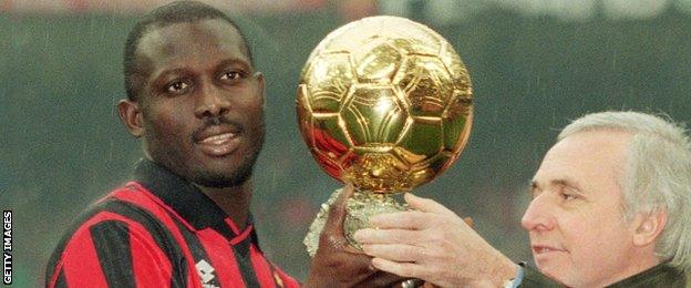 George Weah holds the Ballon d'Or in 1995