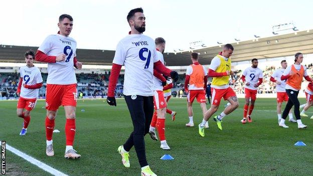 Wigan's players all wear special t-shirts to support Charlie Wyke during their warm-up