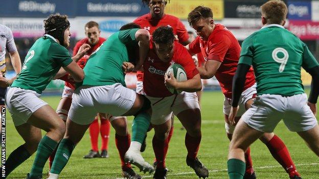 Josh Reynolds of Wales takes on Jack Aungier of Ireland