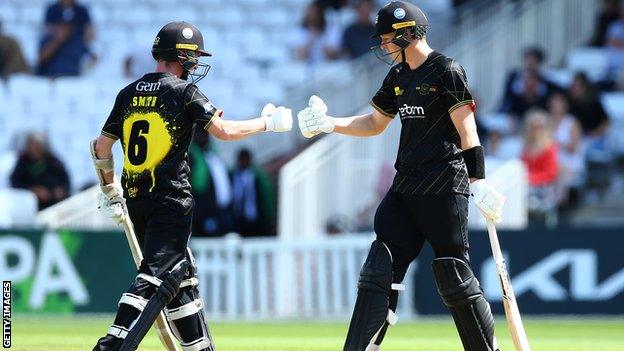 Tom Smith (left) and George Scott (right) batting for Gloucestershire