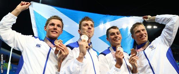 Duncan Scott, Stephen Milne, Daniel Wallace and Mark Szaranek celebrate their 4x200m relay bronze