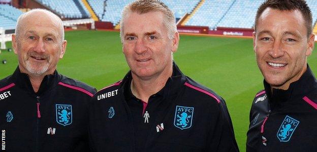 Dean Smith (centre), with assistant head coaches Richard O'Kelly (left) and John Terry