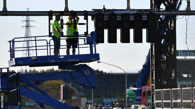 The lights at the start line are put back up after being taken down to protect against Typhoon Hagibis