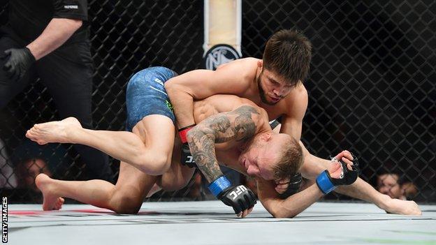 Henry Cejudo grappling with TJ Dillashaw
