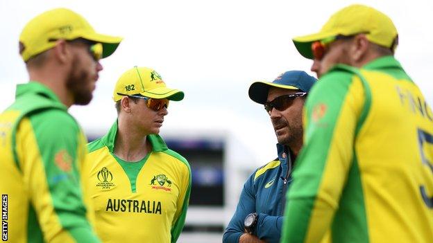 (From left to right) Australia batsmen David Warner, Steve Smith, coach Justin Langer and captain Aaron Finch talk during a warm-up session