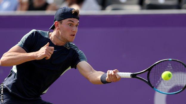 Jack Draper returns a ball against Emil Ruusuvuori at Queen's