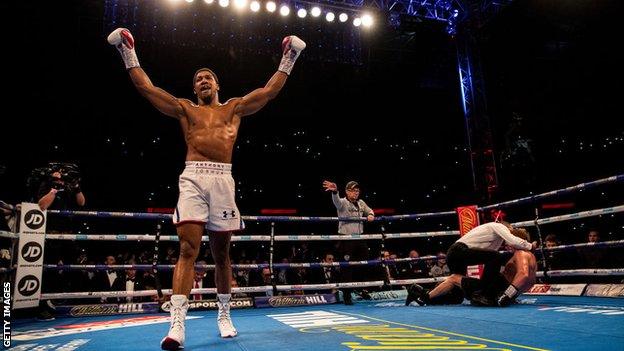 Anthony Joshua celebrates beating Alexander Povetkin