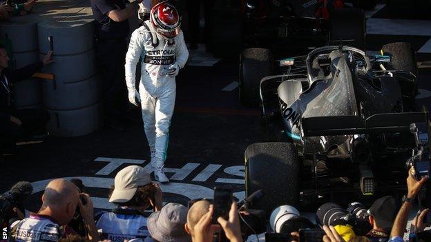 Lewis Hamilton looks at his Mercedes car after the Australian Grand Prix