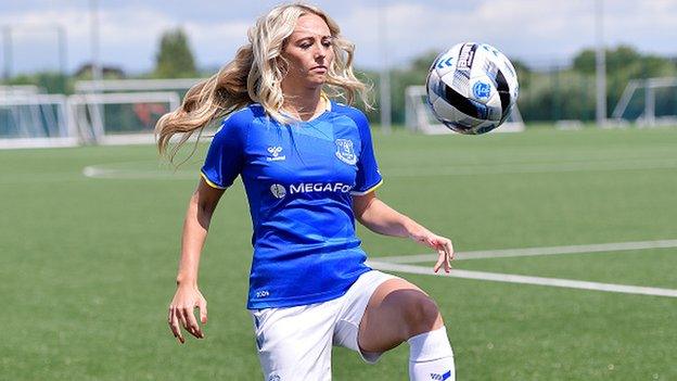 Toni Duggan playing with a football at her signing announcement