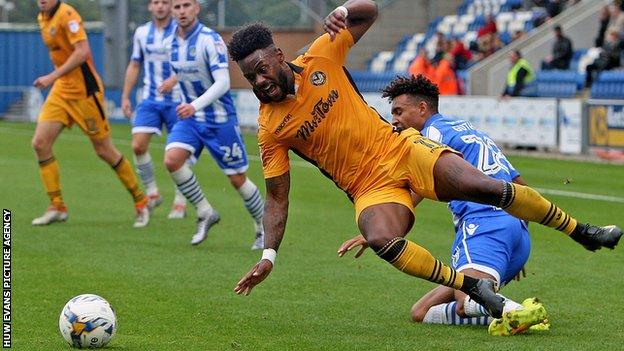 Jennison Myrie-Williams is tackled by a Colchester defender