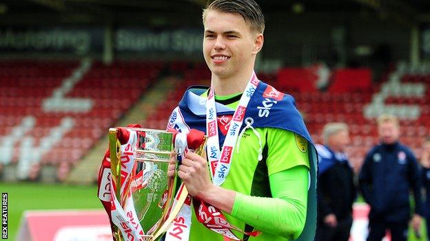 Josh Griffiths celebrates with the League Two title