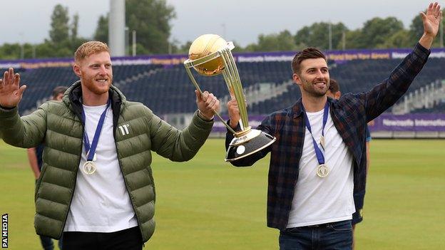 Ben Stokes and Mark Wood with the World Cup trophy