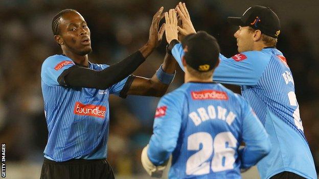 Sussex bowler Jofra Archer (left) celebrates taking the wicket of Ollie Pope