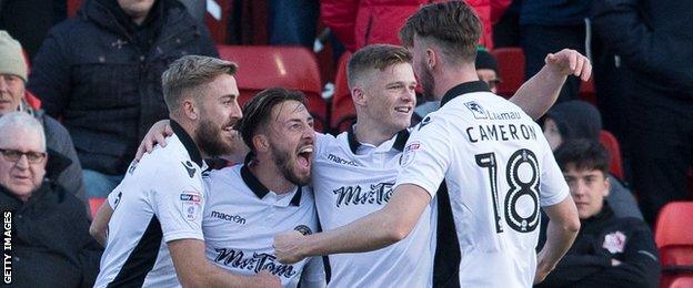 Josh Sheehan is congratulated by team-mates after giving Newport the lead