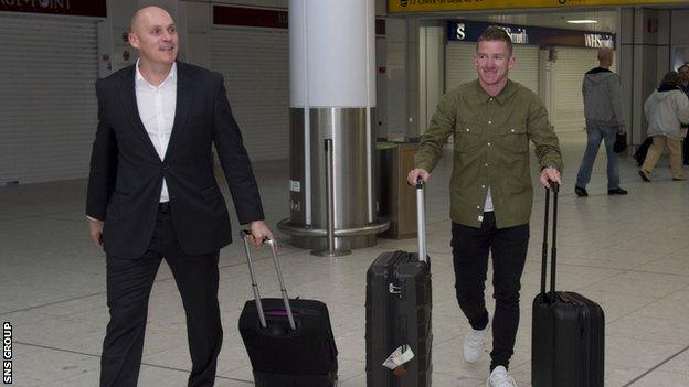 Jonny Hayes (right) at Glasgow Airport