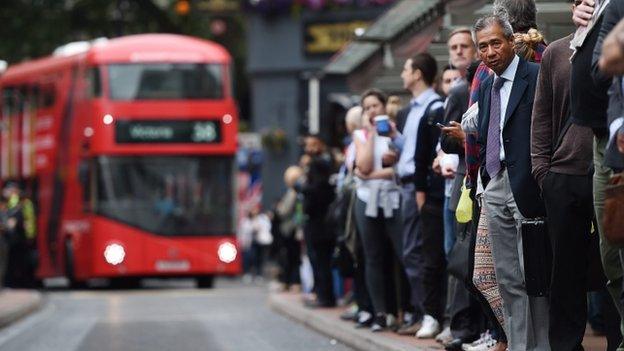 Commuters queue for buses at Victoria Station